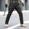 Custom black tactical cargo pants for outdoor and mission use with durable fabric and functional pockets