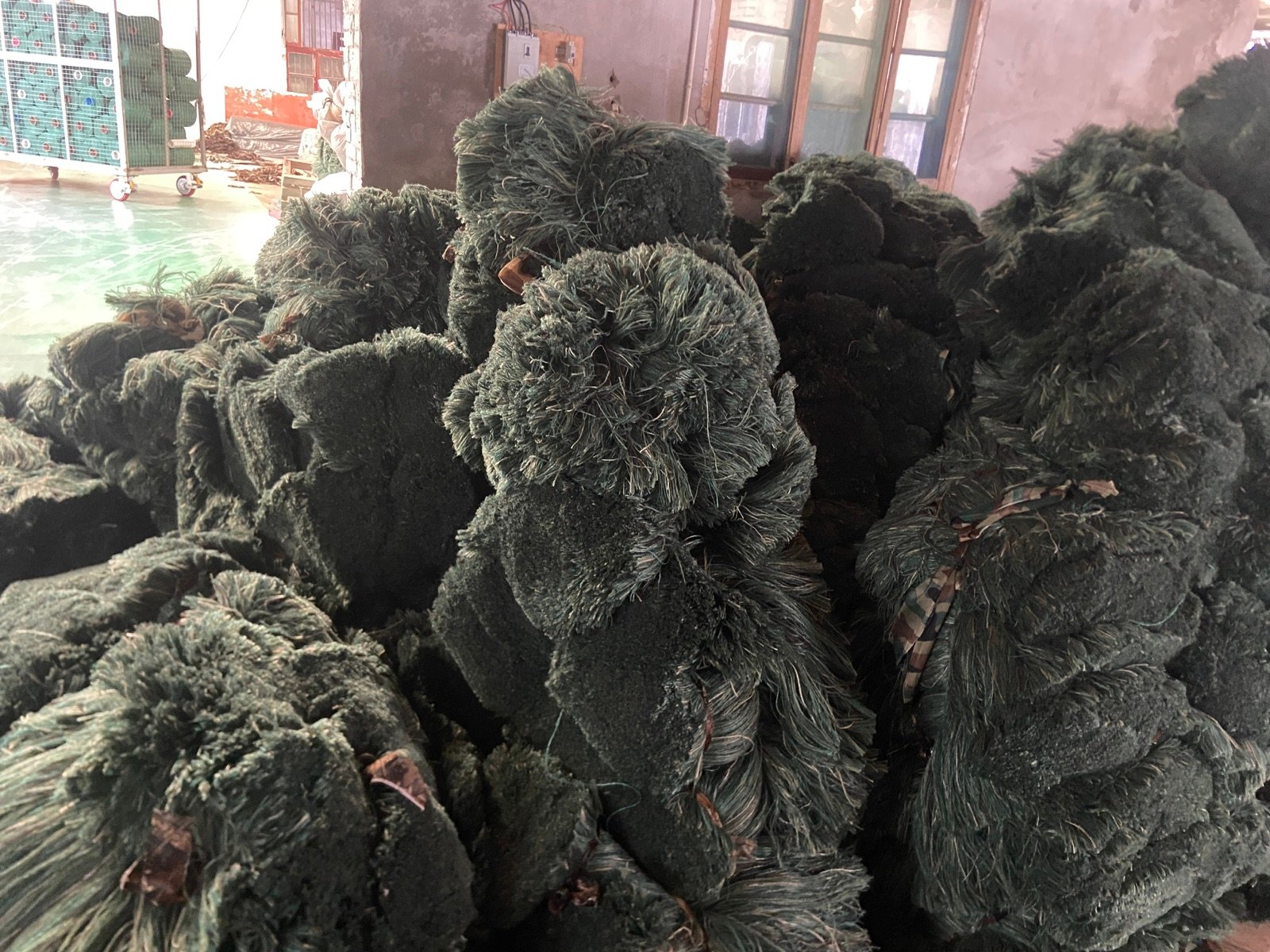 Finished green ghillie suits in the workshop