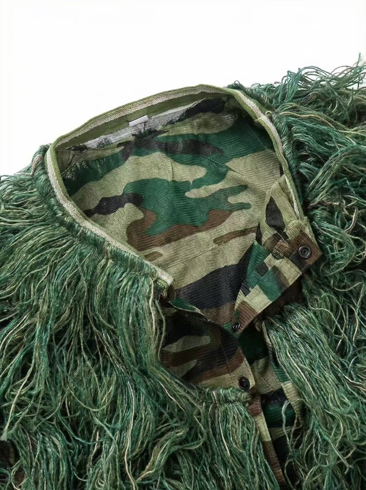 Close-up of a ghillie suit mesh base and yarn construction